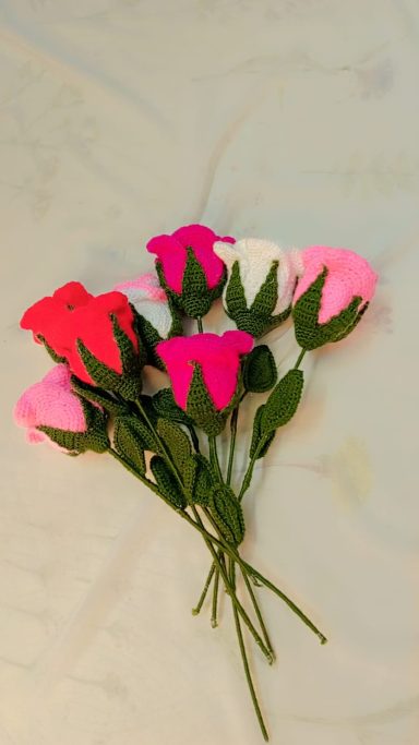 A bouquet of pink, white, and red flowers on a light surface.